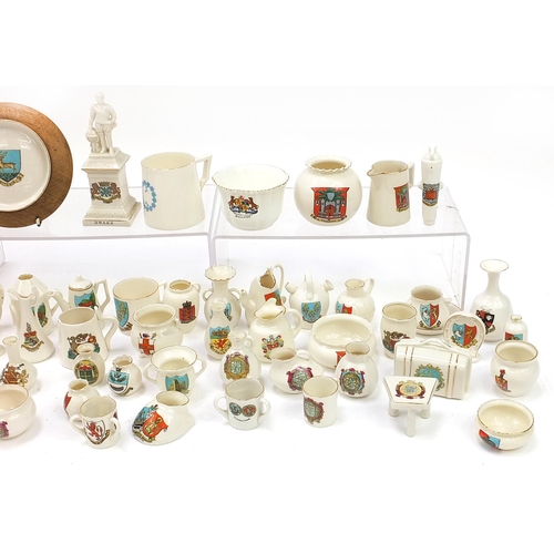 1362 - Collection of crested china, some Goss including shoes, lighthouses, cauldrons and cannon, the large... 