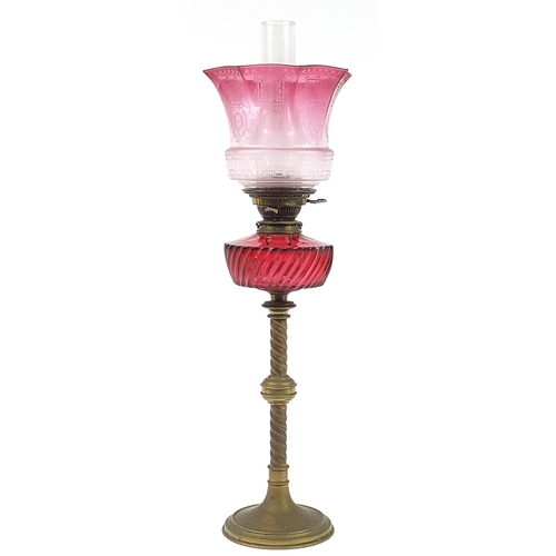 47 - Victorian brass oil lamp with cranberry glass reservoir and shade, impressed Hinks & Sons, 69cm high