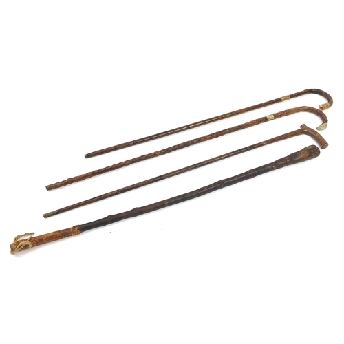 1206 - Four walking sticks including a bamboo example with gilt metal mounts, the largest 89cm in length