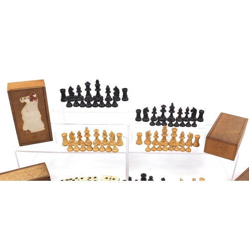 1477 - Three boxwood and ebonised chess sets together with ebony and bone Dominoes, each with pine cases