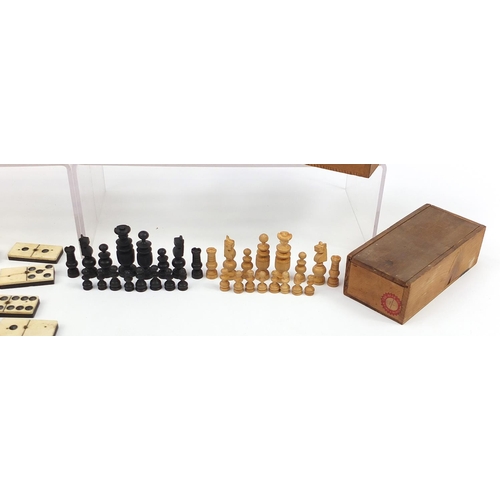 1477 - Three boxwood and ebonised chess sets together with ebony and bone Dominoes, each with pine cases