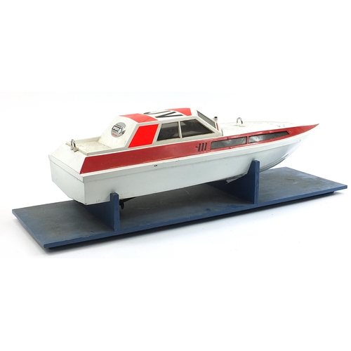 1052 - Large remote controlled speedboat shell on display stand, the boat 98cm in length