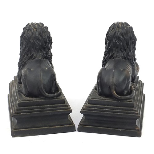 1090 - Large pair of bronzed recumbent lions, 25cm in length