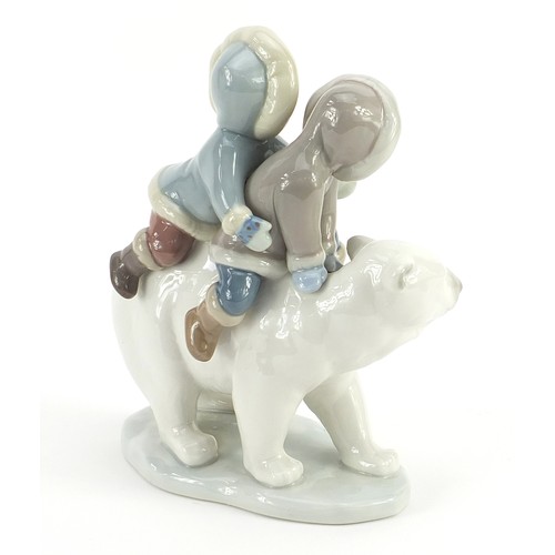 525 - Lladro figure group of young Eskimos on a polar bear, 17cm high