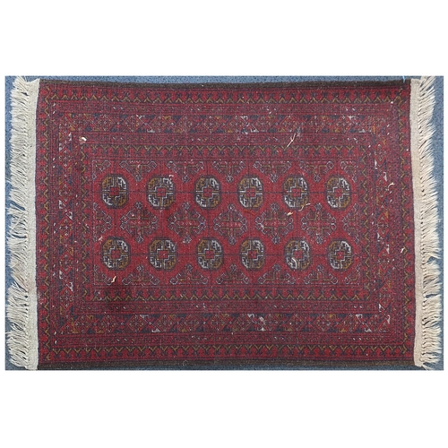 872 - Red ground rug having an all over geometric design, 135cm x 80cm