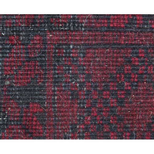 847 - Red and black ground rug having all over geometric design, 225cm x 145cm