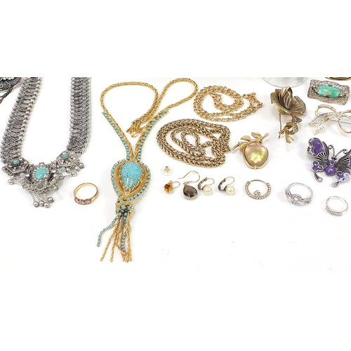 1360A - Costume jewellery and a glass display case, including rings, brooches and necklaces, the cabinet 33c... 