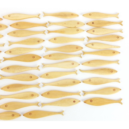 309 - Collection of antique carved bone fish gaming counters, each 6.5cm in length