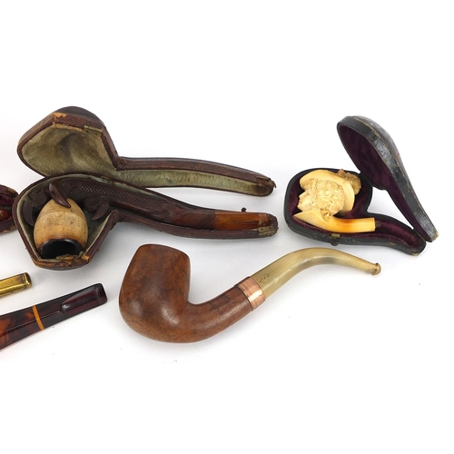 132 - Smoking pipes and cheroot holders including three Meerschaum type pipes, one carved in the form of a... 