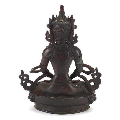 677 - Chino Tibetan patinated bronze figure of a deity, 21cm high