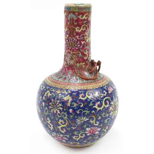 619 - Chinese porcelain vase decorated in relief with a dragon, hand painted with flower heads amongst scr... 