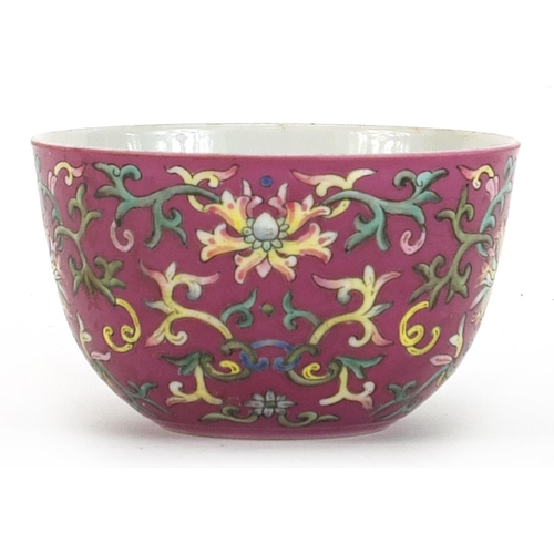 153 - Chinese porcelain pink ground bowl hand painted in the famille rose palette with flower heads amongs... 