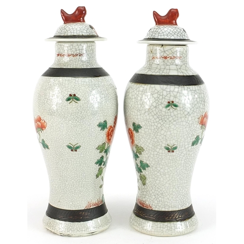 225 - Pair of Chinese crackle glaze baluster vases and covers hand painted in the famille verte palette wi... 