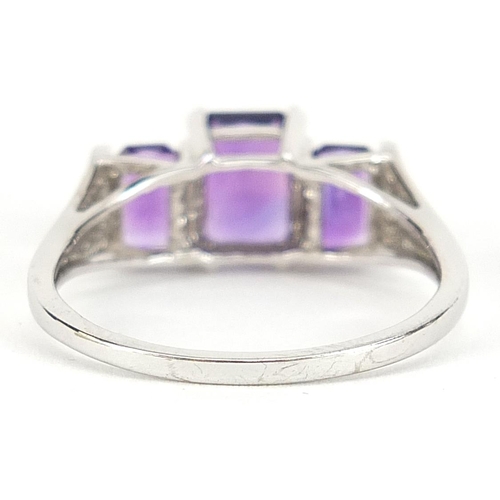 1738 - 9ct white gold amethyst three stone ring, size T, 2.8g