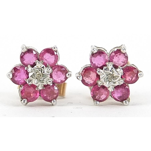 1831 - Pair of 9ct gold ruby and diamond flower head stud earrings, 9.5mm in diameter, 1.4g