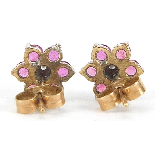 1831 - Pair of 9ct gold ruby and diamond flower head stud earrings, 9.5mm in diameter, 1.4g