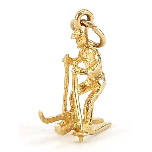 2125 - 9ct gold man on skis charm, 1.6cm high, 1.1g