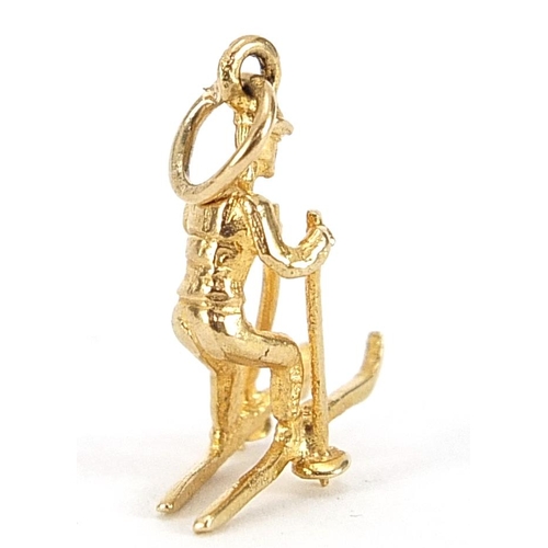 2125 - 9ct gold man on skis charm, 1.6cm high, 1.1g