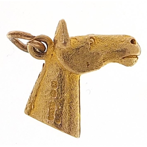 2076 - 9ct gold horsehead charm, 1.5cm in length, 2.2g