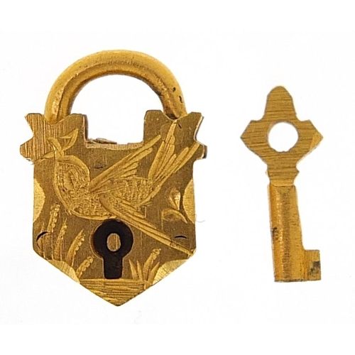 1736 - Yellow metal padlock and key jewellery clasp engraved with a bird 1.5cm high, 2.2g