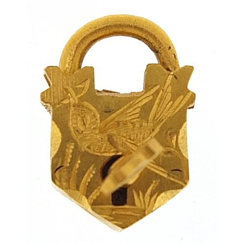 1736 - Yellow metal padlock and key jewellery clasp engraved with a bird 1.5cm high, 2.2g