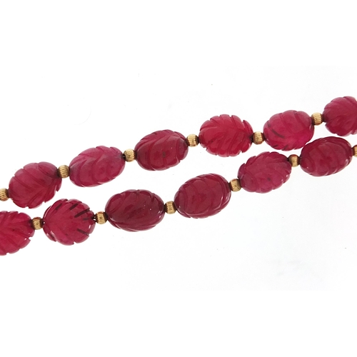 1972 - 14ct gold carved purple stone bead necklace, 52cm in length, 58.7g