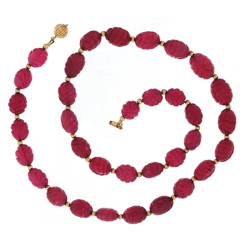 1972 - 14ct gold carved purple stone bead necklace, 52cm in length, 58.7g