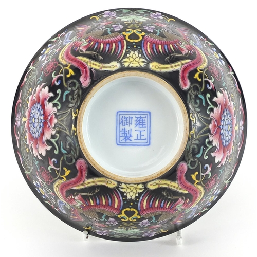 1113 - Chinese porcelain bowl hand painted in the famille noir palette with phoenixes amongst flowers, four... 