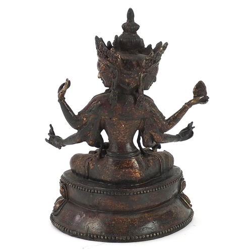 427 - Chino Tibetan partially gilt bronze figure of seated Buddha, 18cm high