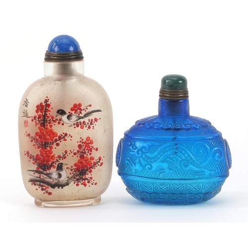 1006 - Two Chinese glass snuff bottles including one internally hand painted with birds amongst peony bloss... 