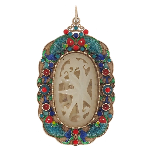 2027 - Chinese white metal and enamel pendant inset with a carved celadon jade panel, 7cm x 4cm