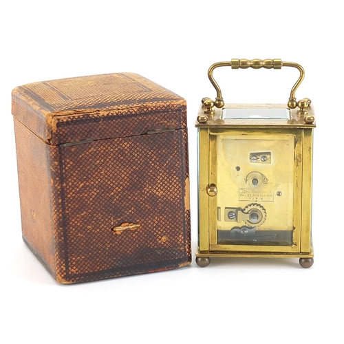 408 - John Wanamaker, 19th century brass cased carriage clock with enamelled dial having Arabic numerals a... 