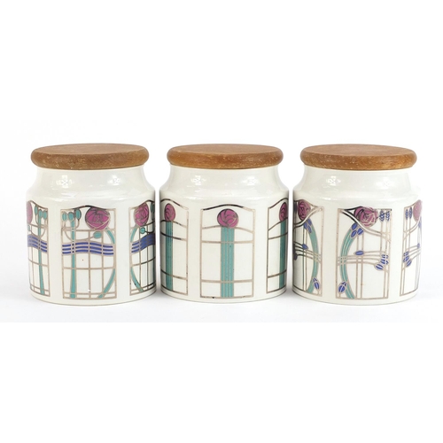 744 - Three Dunoon Mackintosh design storage jars with lightwood lids by Caroline Bessey, each 13cm high