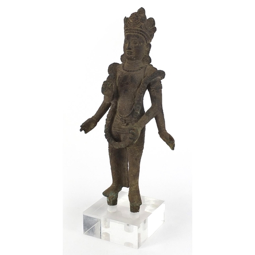 91 - South East Asian patinated bronze goddess raised on a square Perspex block base, overall 36cm high