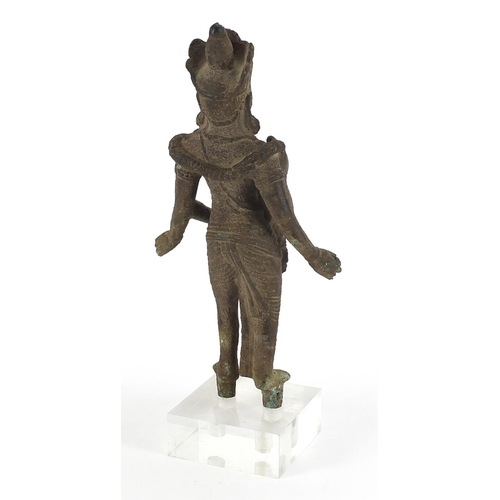 91 - South East Asian patinated bronze goddess raised on a square Perspex block base, overall 36cm high