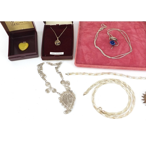 905 - Silver and white metal jewellery including filigree necklace, pendants on chains, Canadian leaf and ... 