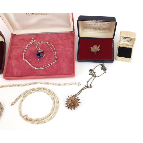 905 - Silver and white metal jewellery including filigree necklace, pendants on chains, Canadian leaf and ... 