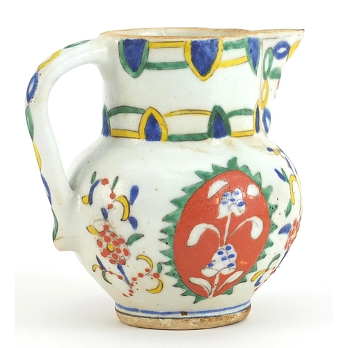 73 - Turkish Kutahya pottery jug hand painted with flowers, 11.5cm high