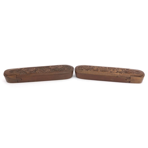 200 - Pair of Islamic wooden pen boxes carved with leaves and flowers, each 24.5cm in length