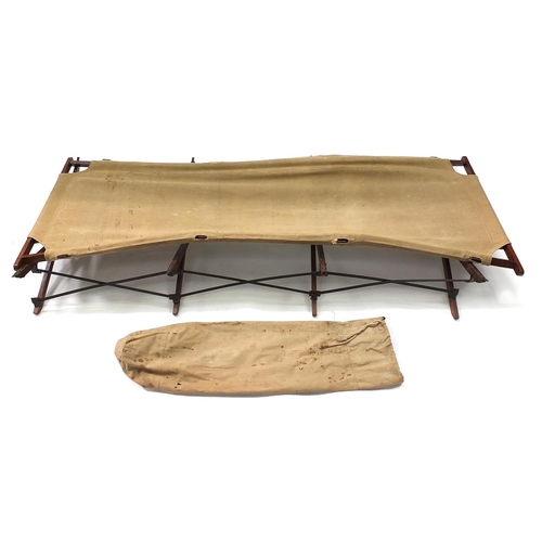 2348 - Military interest folding campaign bed with various impressed marks , 170cm in length