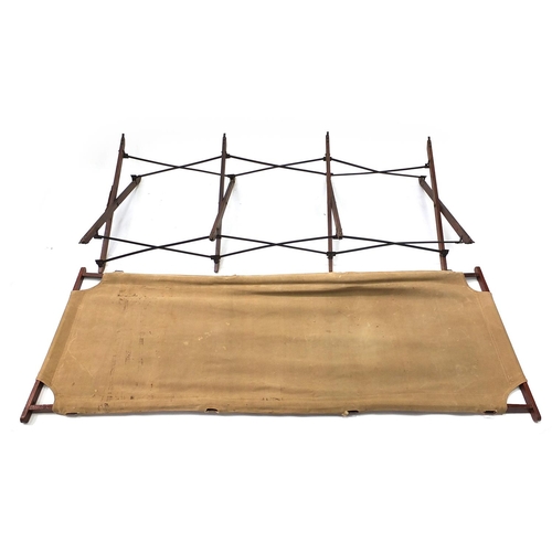 2348 - Military interest folding campaign bed with various impressed marks , 170cm in length