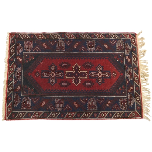 797 - Rectangular Turkish red and blue ground rug having an all over abstract design, 185cm x 118cm