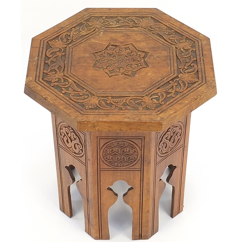 868 - Manner of Liberty & Co, Moorish style octagonal occasional table carved with flowers and stylised ro... 