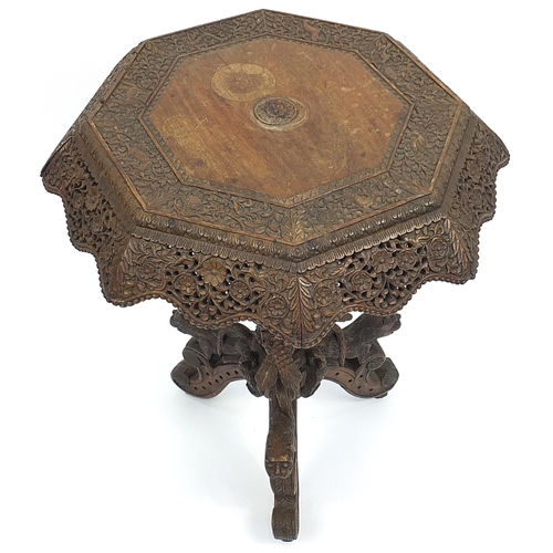 800 - Burmese side table with octagonal top profusely carved with wild animals amongst flowers, with serpe... 