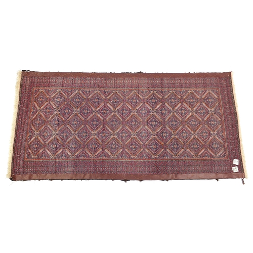 815 - Rectangular Persian red and blue ground rug having an all over geometric design, 172cm x 82cm