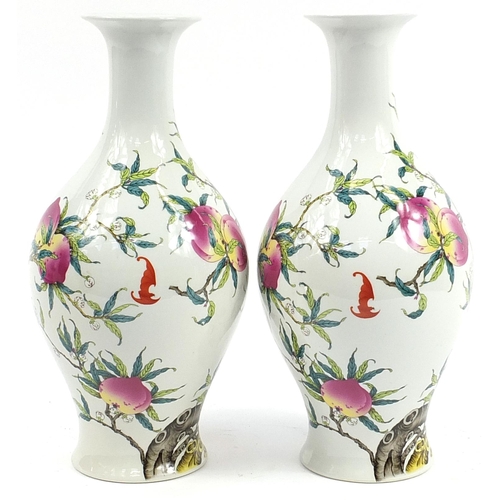 1227 - Pair of Chinese porcelain vases decorated with bats amongst peaches, each 40cm high