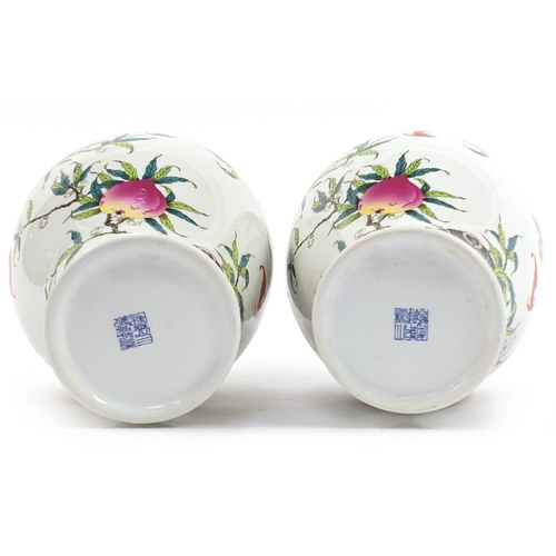 1227 - Pair of Chinese porcelain vases decorated with bats amongst peaches, each 40cm high