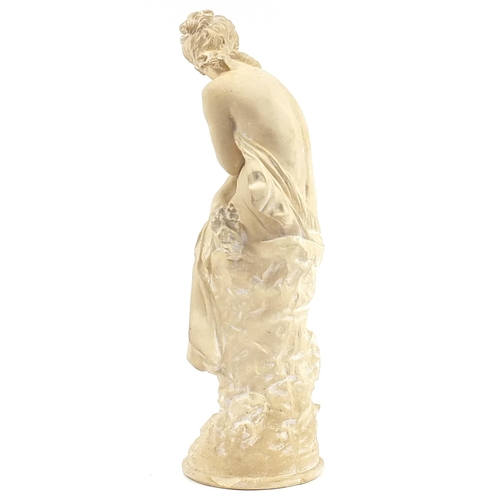 1306 - Classical plaster sculpture of a semi nude female seated on a rock, 65cm high