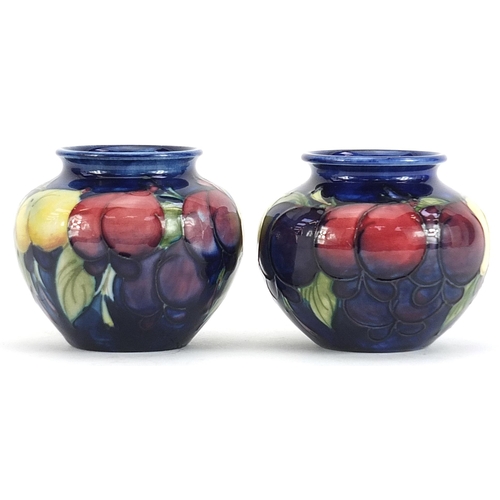 327 - Pair of Moorcroft Pottery vases hand painted with fruits, each 7cm high