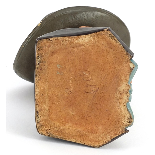 1194 - Continental terracotta tobacco box and cover in the form of a Jewish man, 17cm high